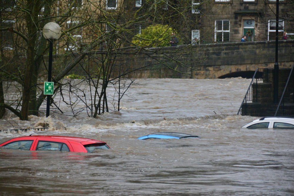 Cars submerged in a flooded river street